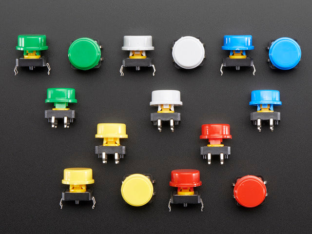 Top-down shot of 15 colorful round tactile button switches in green, yellow, red, blue, and white.