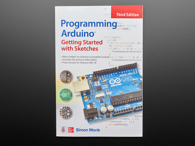Front cover of "Programming Arduino" By Simon Monk - Third Edition.  Cover features a closeup of a rectangular ocean-blue rectangular microcontroller, the Arduino Uno.