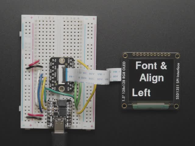 Overhead video of OLED breakout wired up on breadboard to QT Py and BFF driver board. Video displays a rainbow hexagon and accelerometer data.