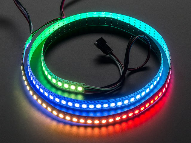 Adafruit NeoPixel Digital RGB LED Strip wired to a microcontroller, with all the LEDs in a rainbow