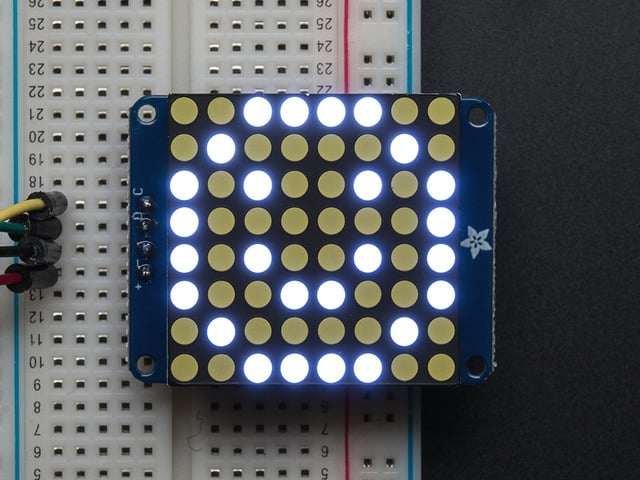 Assembled and powered on Small 1.2" 8x8 Ultra Bright White LED Matrix. A white graphical smiley is displayed.