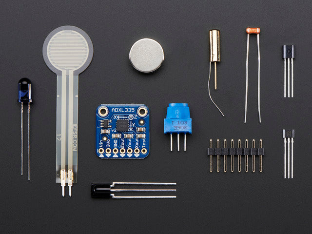 Kit components showing various sensors, LED, magnet and some header