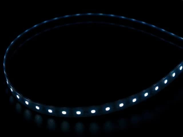 Coiled cool white LED strip with LEDs changing color throughout rainbow and also white