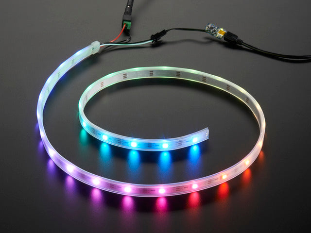 Adafruit NeoPixel Digital RGB LED Strip wired to a microcontroller, with all the LEDs in a rainbow