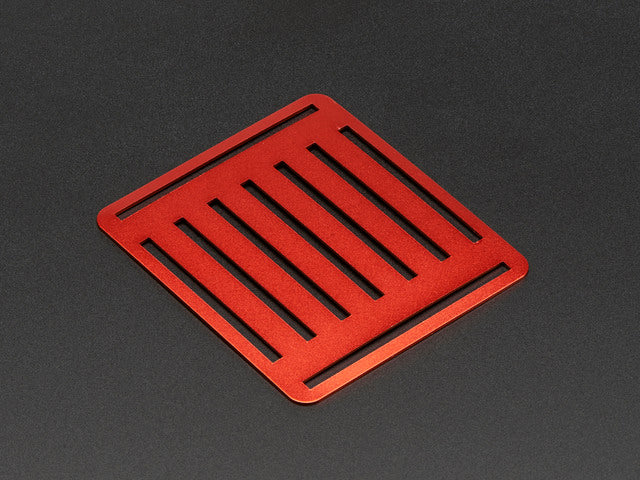 Angled shot of slotted red aluminum sheet.