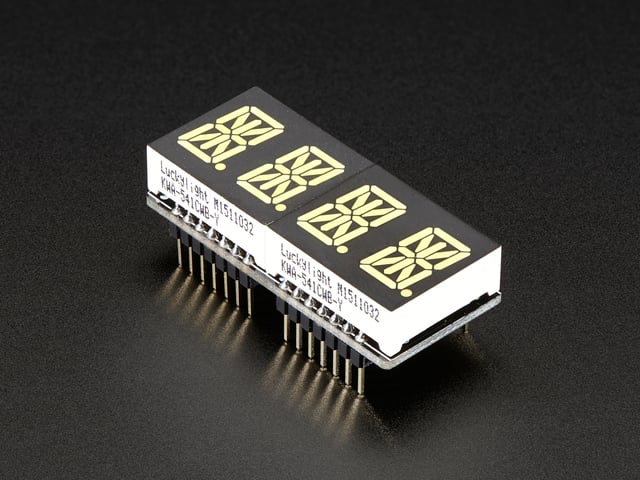 Angled shot of a rectangular shaped Quad Alphanumeric Display breakout board with an LED matrix soldered on.