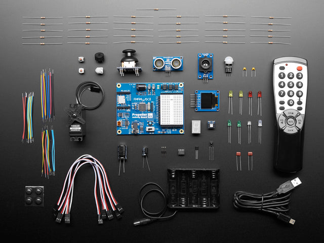 Parallax Blockly Prop Starter Kit showing PCB, many components and remote control