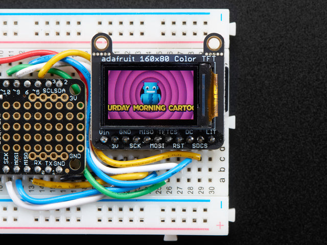 TFT breakout wired up on breadboard, showing colorful image