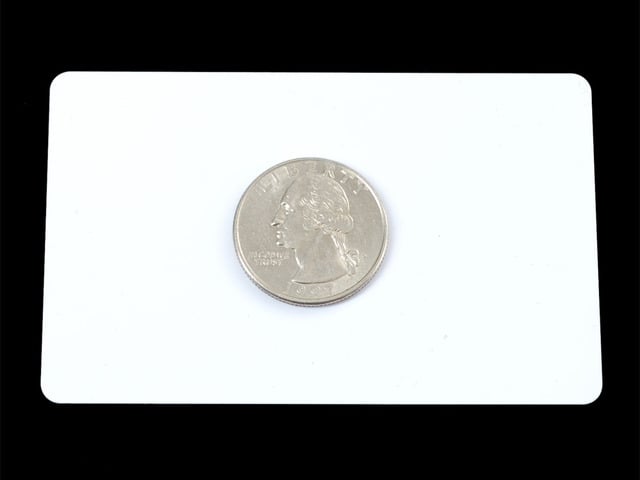 White card with quarter on top