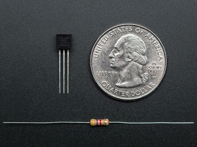 DS18B20 Digital temperature sensor next to a US quarter and above a resister. 