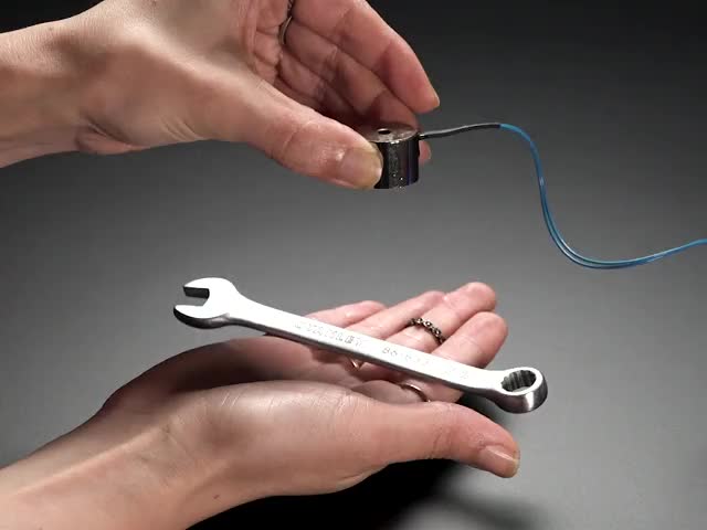 Solenoid holding up a small wrench, then releasing it