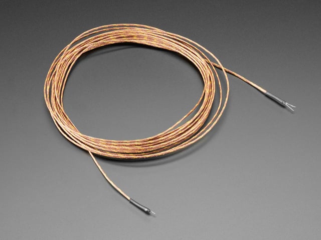 Angled shot of a coiled up 5m Thermocouple Type-K Glass Braid Insulated wire. 