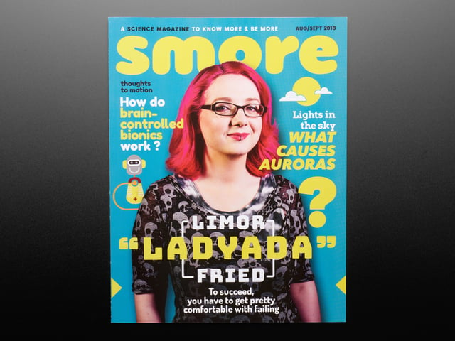 Topdown shot of Smore magazine cover. A bespectacled white woman, Limor Fried a.k.a. Ladyada, in black clothes with pink, shoulder-length hair is on the cover.