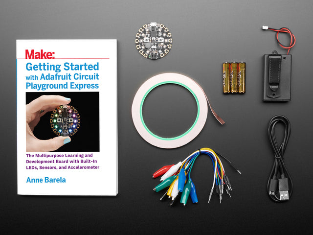 Getting Started with Adafruit Circuit Playground Express book along with a collection of electronic parts included in kit.