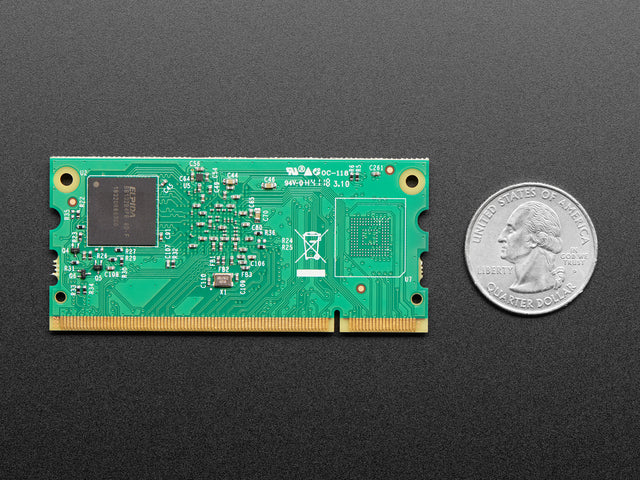 Top of Raspberry Pi Compute Module showing RAM and empty FLASH chip spot, next to Quarter