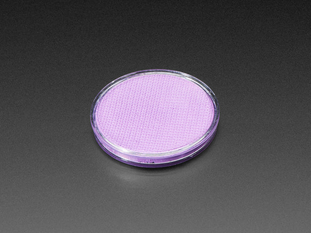 Angled shot of round purple disc of fluorescent paint.