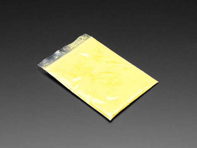 Angled shot of clear baggy containing yellow thermochromic pigment powder.