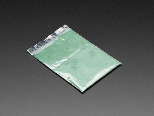 Angled shot of clear baggy containing green thermochromic pigment powder.