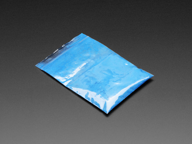 Angled shot of clear baggy containing blue thermochromic pigment powder.