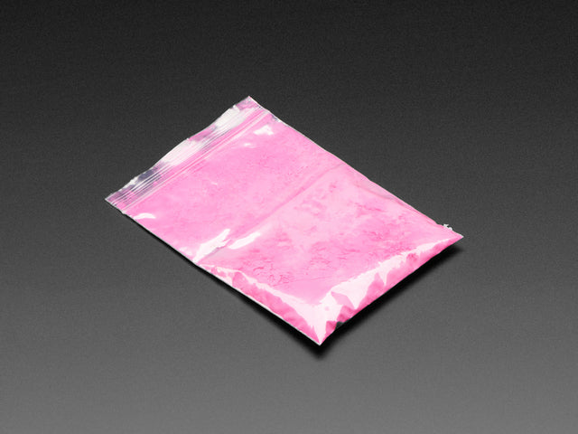 Angled shot of clear baggy containing pink thermochromic pigment powder.