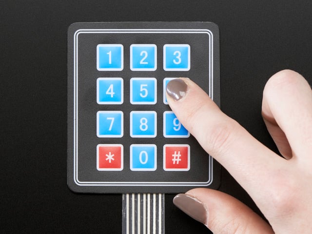 Finger pressing one key of 3x4 keypad