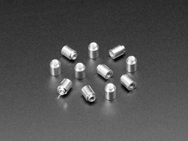 Angled shot of ten 6mm tall M3 standoff nuts.