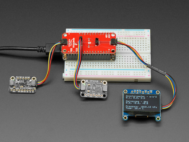 SparkFun Qwiic / Stemma QT FeatherWing with three QT boards plugged into the top