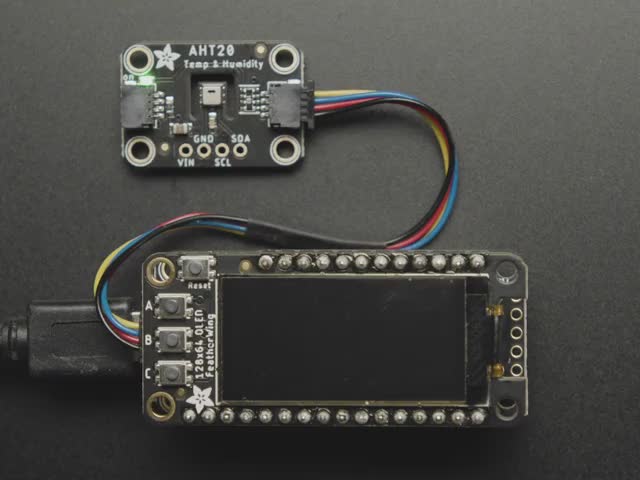  Qwiic connected to a temp and humidity sensor. Display reads "Adafruit" and various Temp and Humidity measures.  