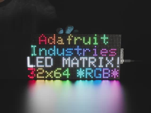 LED RGB matrix 10.2" x 5.1" with "Adafruit Industries LED Matrix" text showing, and LED acrylic slowly covering to make it nicely diffused