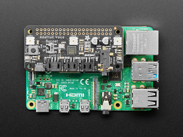 Top down view of a Adafruit Voice Bonnet for Raspberry Pi connected to a Pi