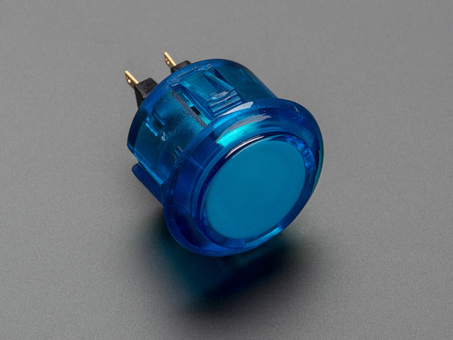 Angled shot of a translucent blue round 30mm arcade button. 