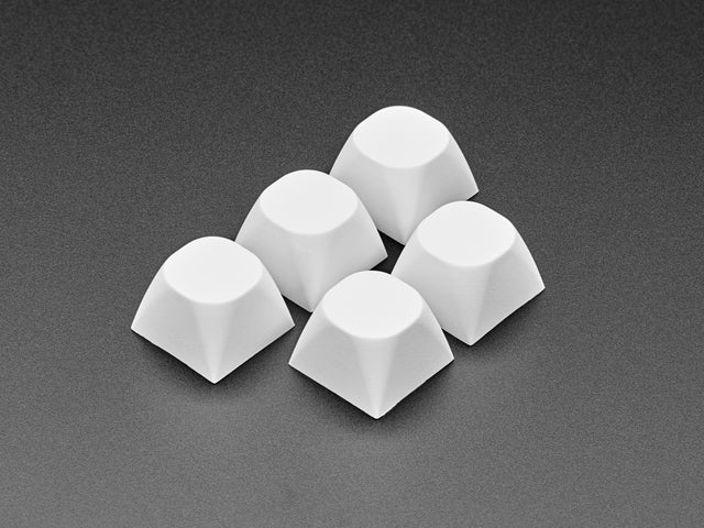 Angled shot of 5 white MA keycaps.