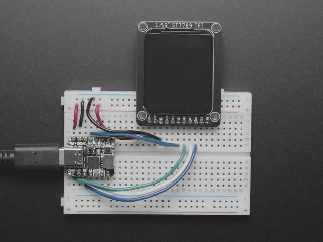 Video of 1.69" 280x240 Round Rectangle Color IPS TFT Display plugged into a breadboard and QT Py. The TFT displays a boot-up screen with "Hello, world!"