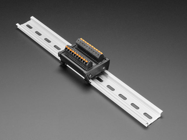 Angled shot of DIN Rail 10x10 to Terminal Block Adapter on a DIN rail.