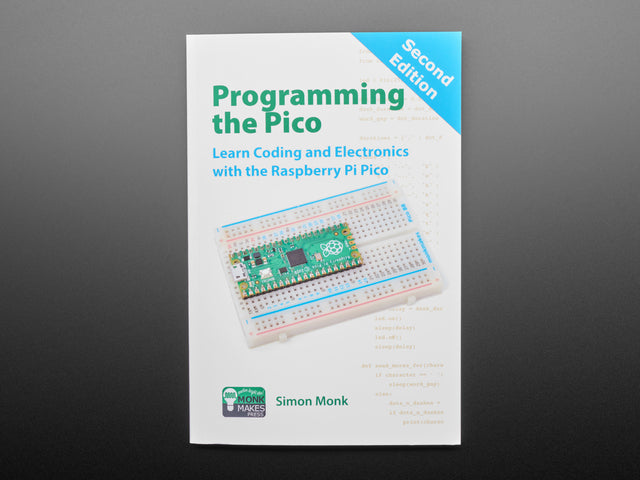 Front cover of technical book: "Programming the Pico. Learn Coding and Electronics with the Raspberry Pi Pico." Cover art is an angled photograph of a long green rectangular microcontroller assembled into a half-size breadboard.