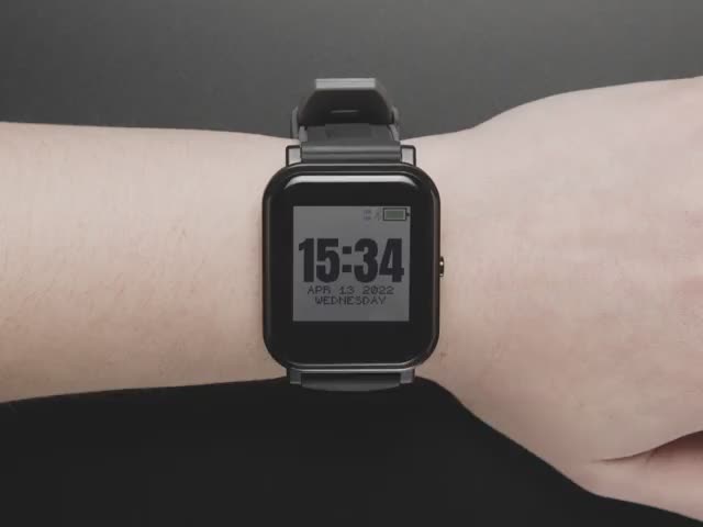 Video of a white woman wearing an open-source watch with colored touchscreen. She uses her pointer finger to scroll through the watch's menu.