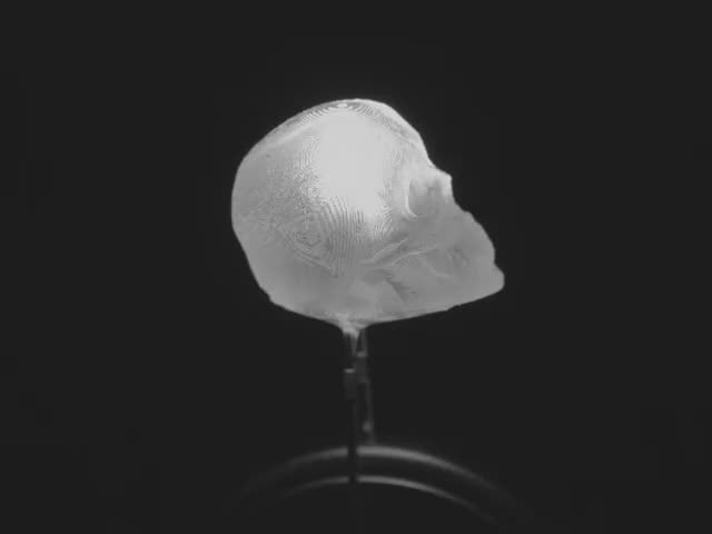 Video of a skull-shaped LED emitting cool white light.