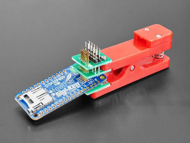 Pogo Pin Probe Clip clipped to a PCB with 2x5 pads.