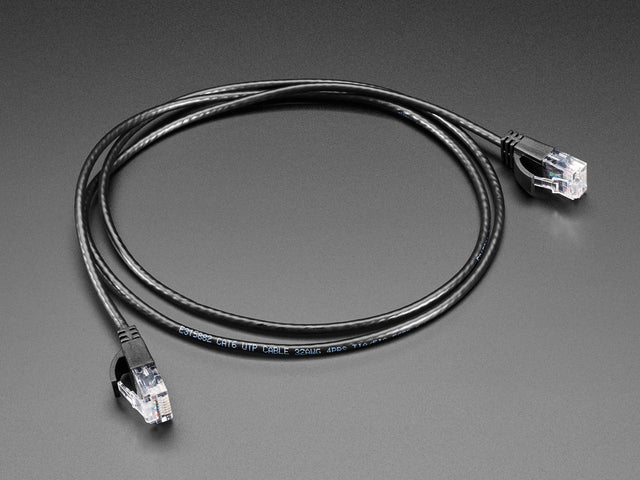 Angled shot of a black coiled Ethernet cable with RJ-45 connectors on both ends.