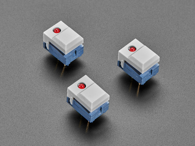 Angled shot of three gray plastic step switches with LED.