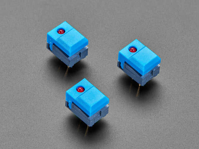 Angled shot of three blue step-switches with LEDs.