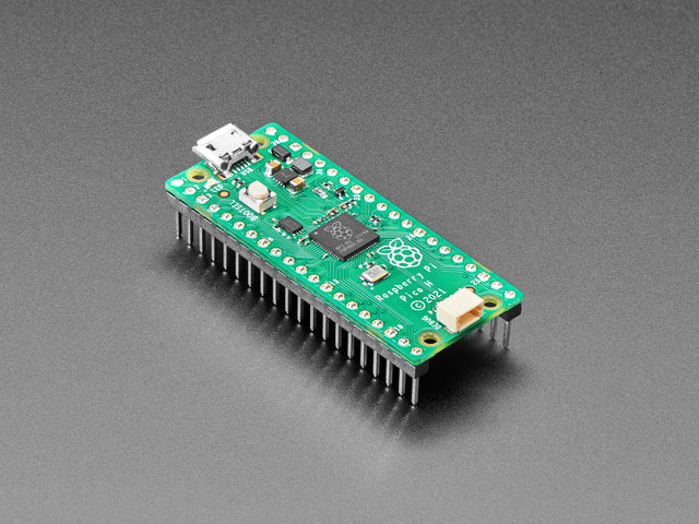 Angled shot of a skinny green microcontroller with headers.