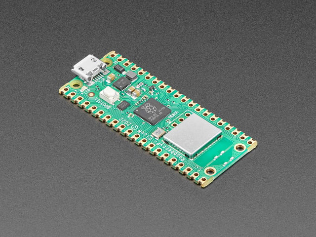 Angled shot of a green microcontroller with castellated pads.