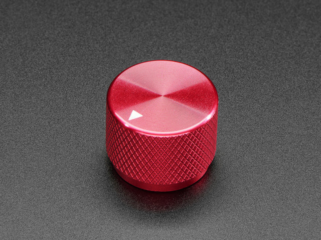 Angled shot of a red aluminum knob. A white triangle on top of the knob points at 7:00. 