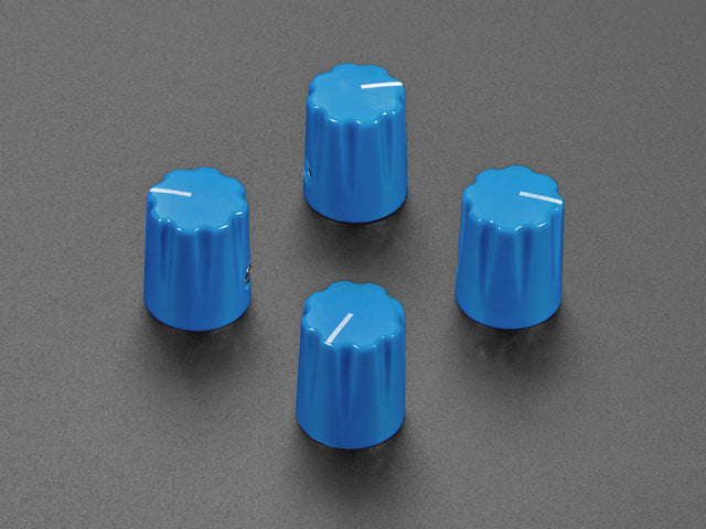 Angled shot of four blue plastic micro knobs.