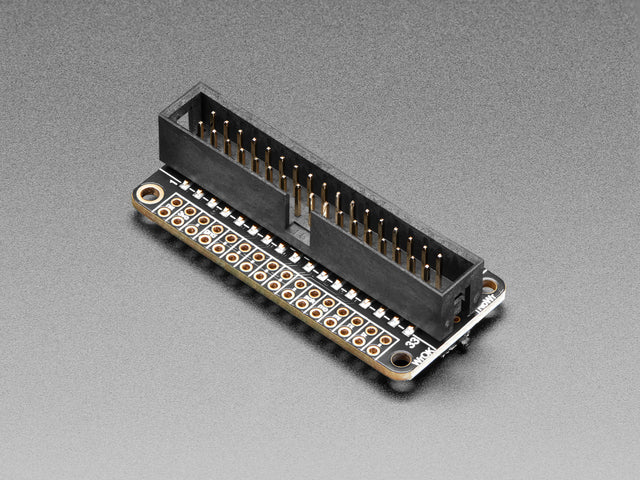 Angled shot of a black rectangular microcontroller with GPIO header.