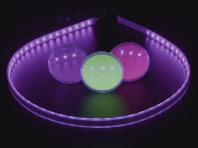 UV LED strip lighting up three pots of fluorescent pigments.