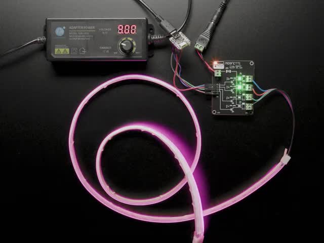Mosfetti board linked up to an LED strip lighting up in an array of colors.