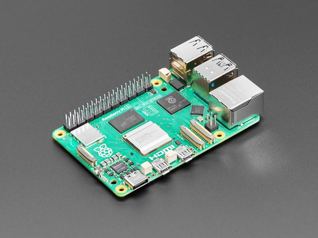 Angled shot of green Raspberry Pi 5 microcontroller.