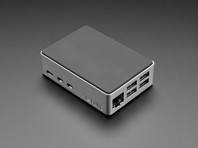 Angled shot of rectangular, aluminum microcontroller enclosure containing a Raspberry Pi computer.